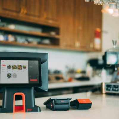 A sleek digital point-of-sale system in a contemporary restaurant setting, showcasing cashless payment technology.